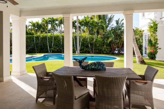 Palmo outdoor dining set and pool area by Ecclestone Signature Homes