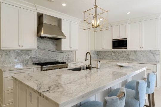 clean modern designed kitchen with stone countertops by Ecclestone Signature Homes
