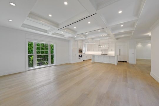 Sandpiper great room and kitchen with wood flooring by ecclestone homes