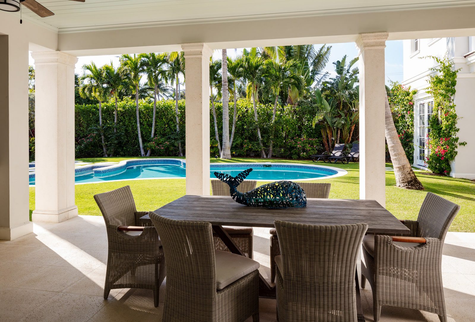 outside patio with chairs and pool - backyard by Ecclestone Homes